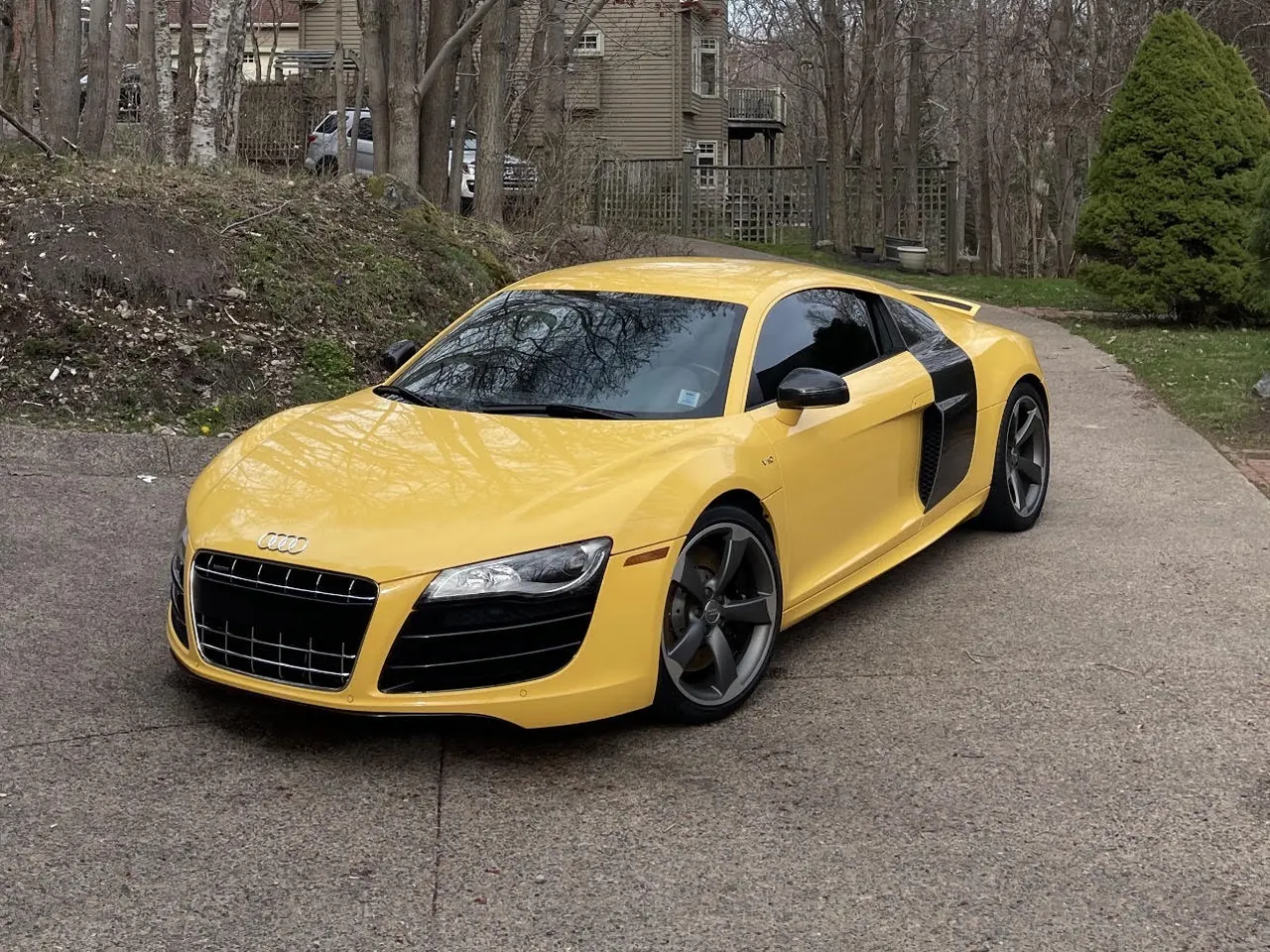 A yellow Audi R8 on a driveway