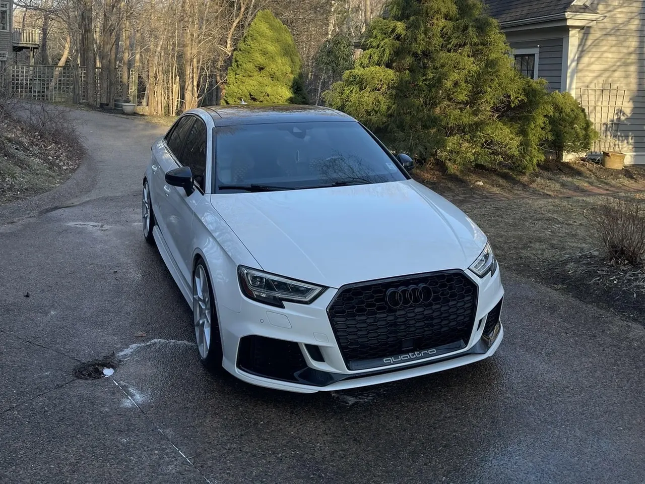 A white Audi RS 3 on a driveway