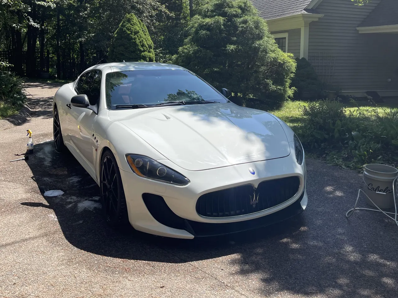 A white Maserati GranTurismo on a driveway